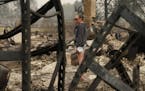 Desiree Pierce reacts as she visits her home destroyed by the Almeda Fire, Friday, Sept. 11, 2020, in Talent, Ore. "I just needed to see it, to get so