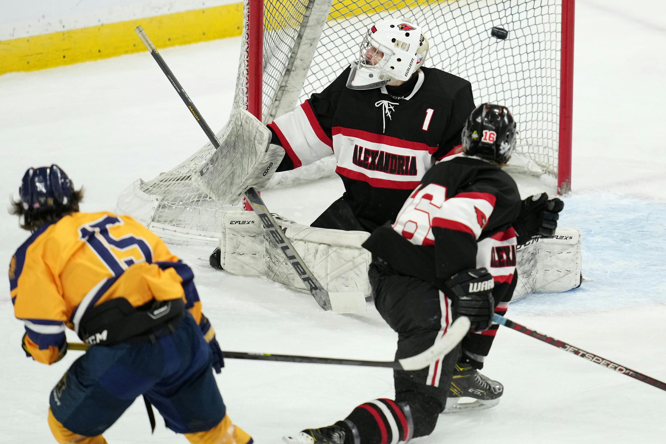 Mahtomedi forward Seth Nelson (15) scores on Alexandria goaltender Elijah Rasmusen (1) in the first period of a MSHSL Class 1A quarterfinal hockey game between Alexandria and Mahtomedi.