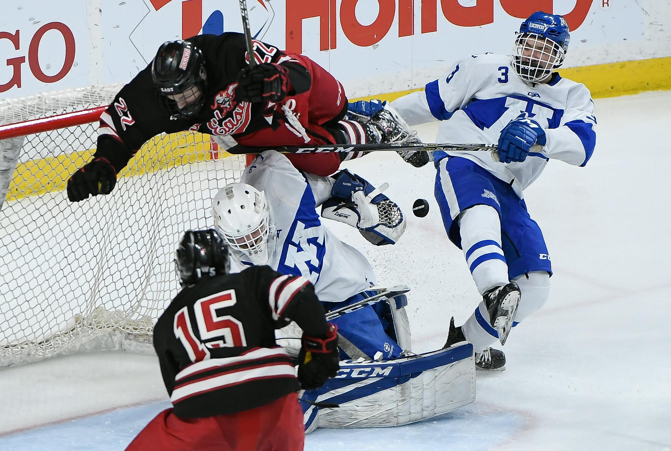 Duluth East forward Ryder Donovan (22) was upended after colliding with Minnetonka goaltender Charlie Glockner (1) and defenseman Josh Luedtke (3) in the second period. ] AARON LAVINSKY � aaron.lavinsky@startribune.com Minnetonka played Duluth East in the Class 2A boys' hockey championship game on Saturday, March 10, 2018 at Xcel Energy Center in St. Paul, Minn.
