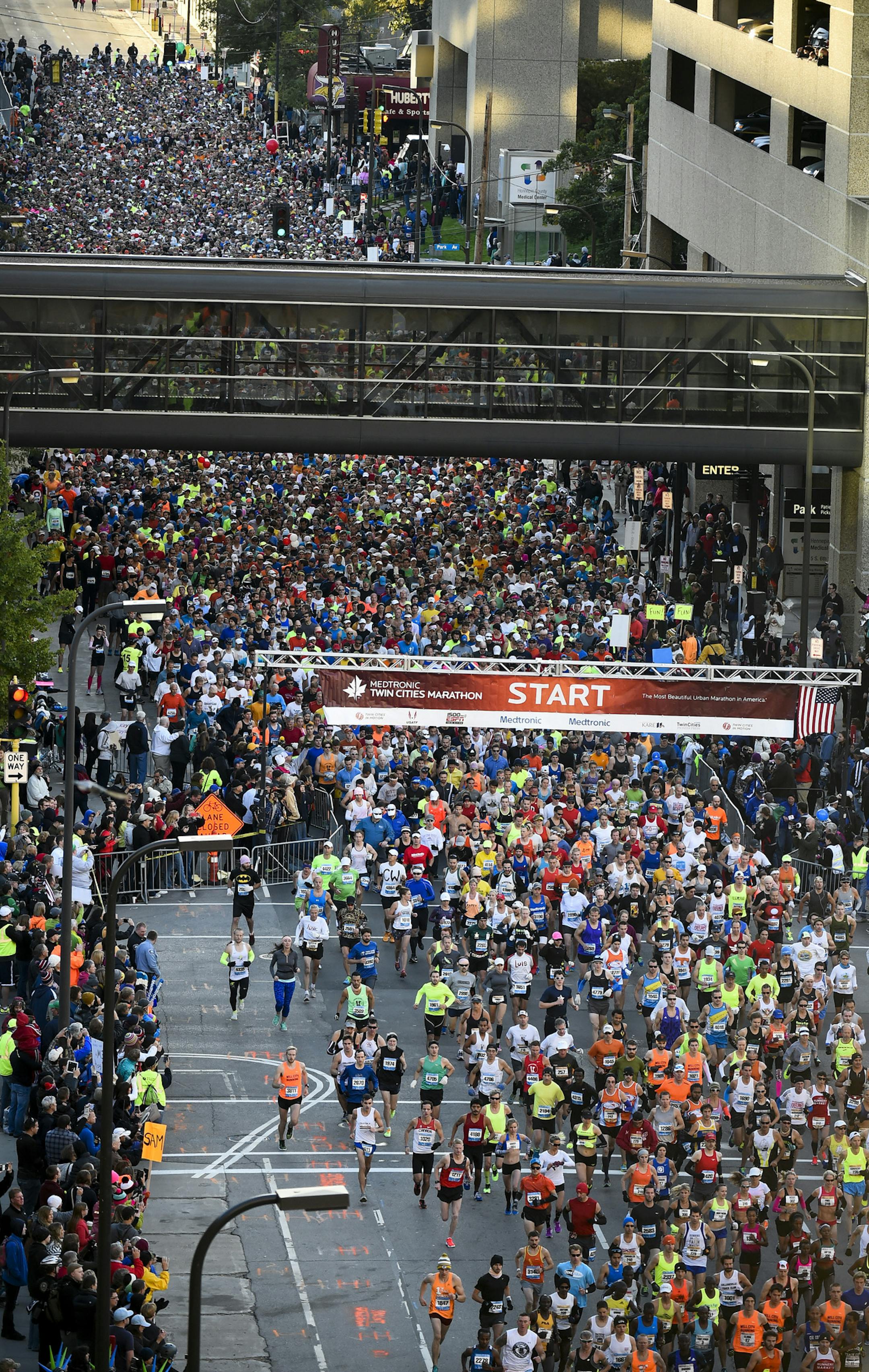 Runners head out at the start of the Twin Cities Marathon, Sunday, Oct. 4, 2015, in Minneapolis. (AP Photo/Craig Lassig)