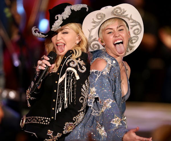 In this Tuesday, Jan. 28, 2014 photo provided by MTV, Miley Cyrus performs with Madonna during the taping of "Miley Cyrus: MTV Unplugged," in the Holl