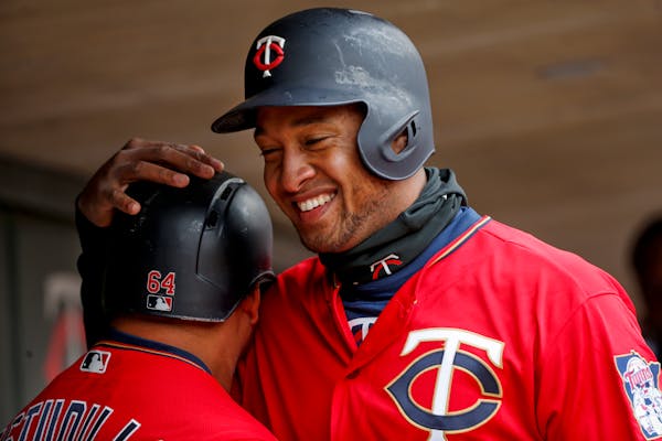The Twins' Willians Astudillo and Jonathan Schoop, right, celebrate their runs against the Indians in the fourth inning