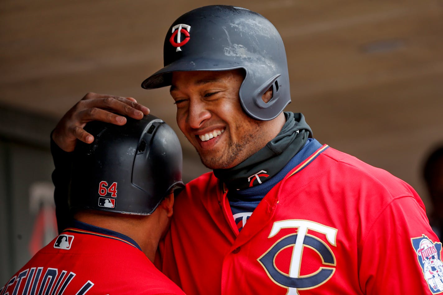 The Twins' Willians Astudillo and Jonathan Schoop, right, celebrate their runs against the Indians in the fourth inning