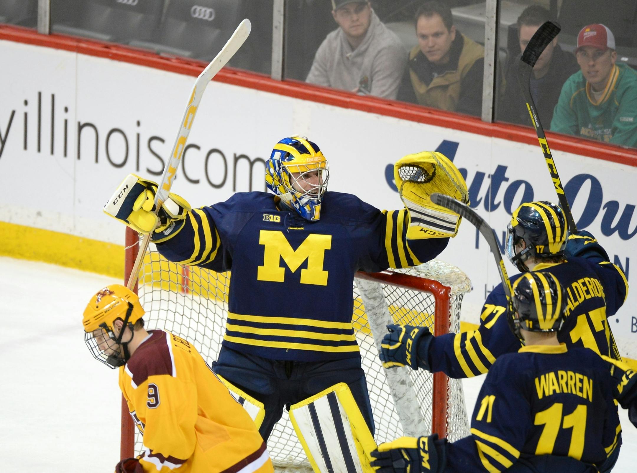 Michigan Wolverines goalie Steve Racine (1) celebrated with teammates after their team's 5-3 victory over the Minnesota Golden Gophers Saturday.