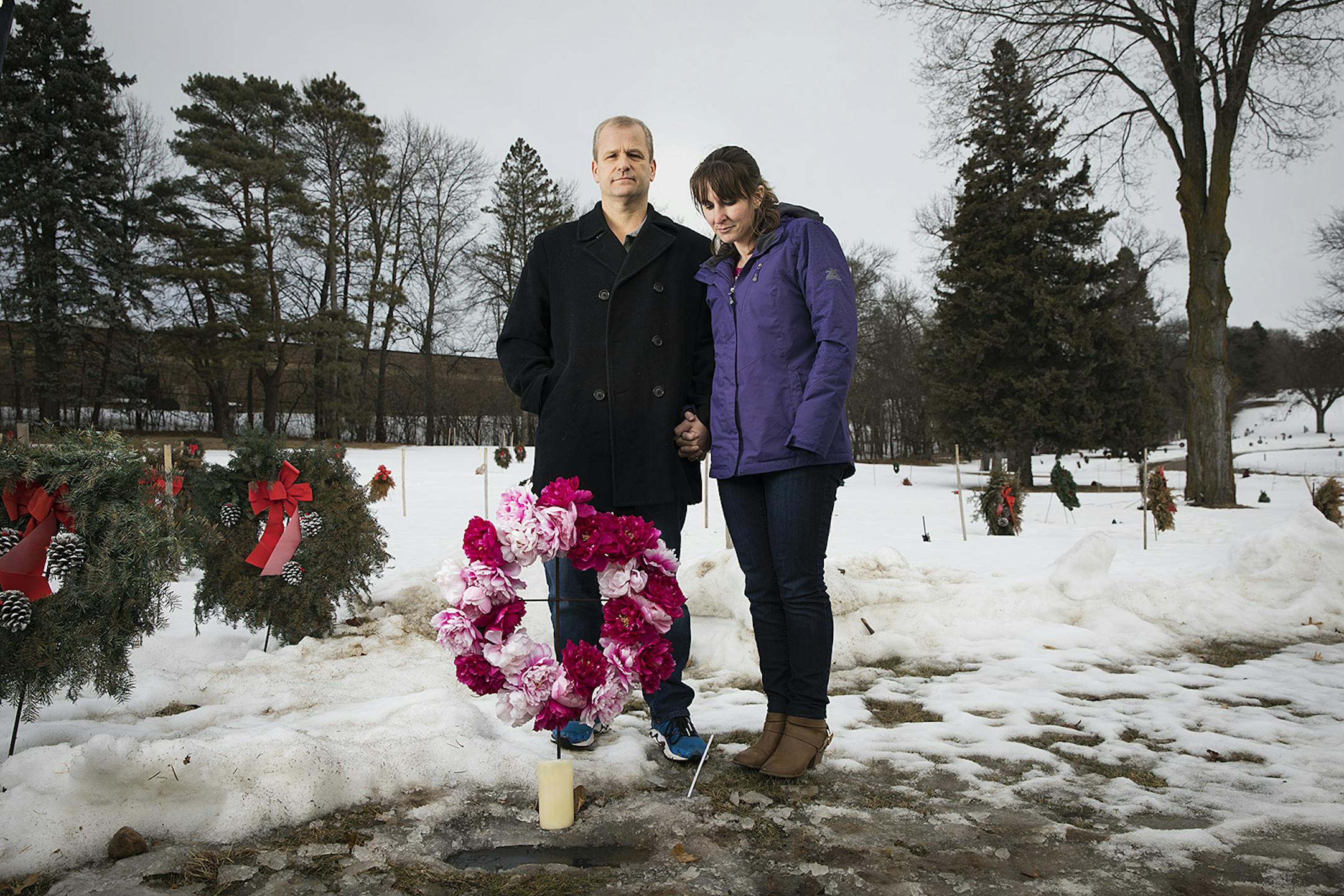 Jon Markle and his wife, Mandy, stood at their daughter Tabitha's grave in Mendota Heights.