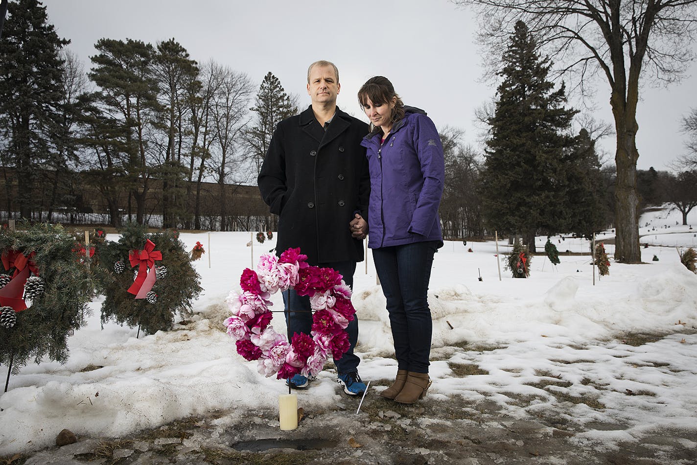 Jon Markle and his wife, Mandy, stood at their daughter Tabitha's grave in Mendota Heights.