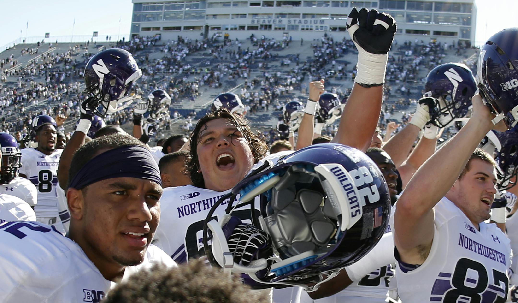 Northwestern players celebrate with after beating Penn State 29-6 in an NCAA college football game in State College, Pa., Saturday, Sept. 27, 2014. (AP Photo/Gene J. Puskar)