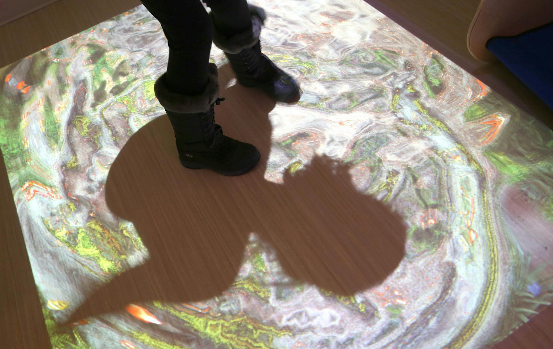 Caroline Marshall, 10, of Eden Prairie, played with the interact projection on the floor in the Snoezelen room. ] (KYNDELL HARKNESS/STAR TRIBUNE) kyndell.harkness@startribune.com In the new pain clinic at Children's Hospital in Minneapolis Min., Thursday, January 15, 2014.