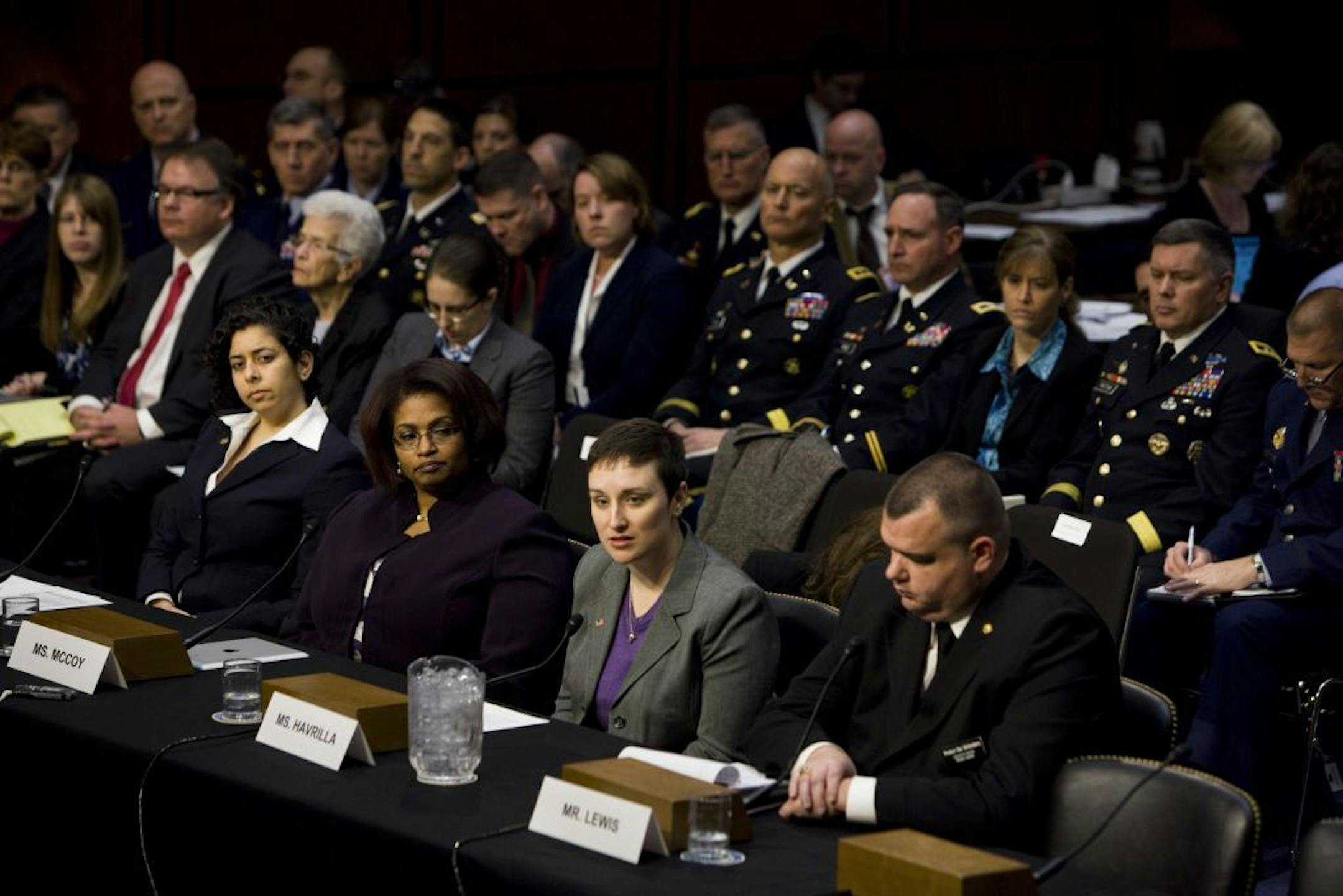 Former Army Sgt. Rebekah Havrilla, center, testifies before the Senate Armed Services Subcommittee on Personnel, in Washington, March 13, 2013. The witnesses were all former service members and victims of either rape, sexual assault and sexual harassment.