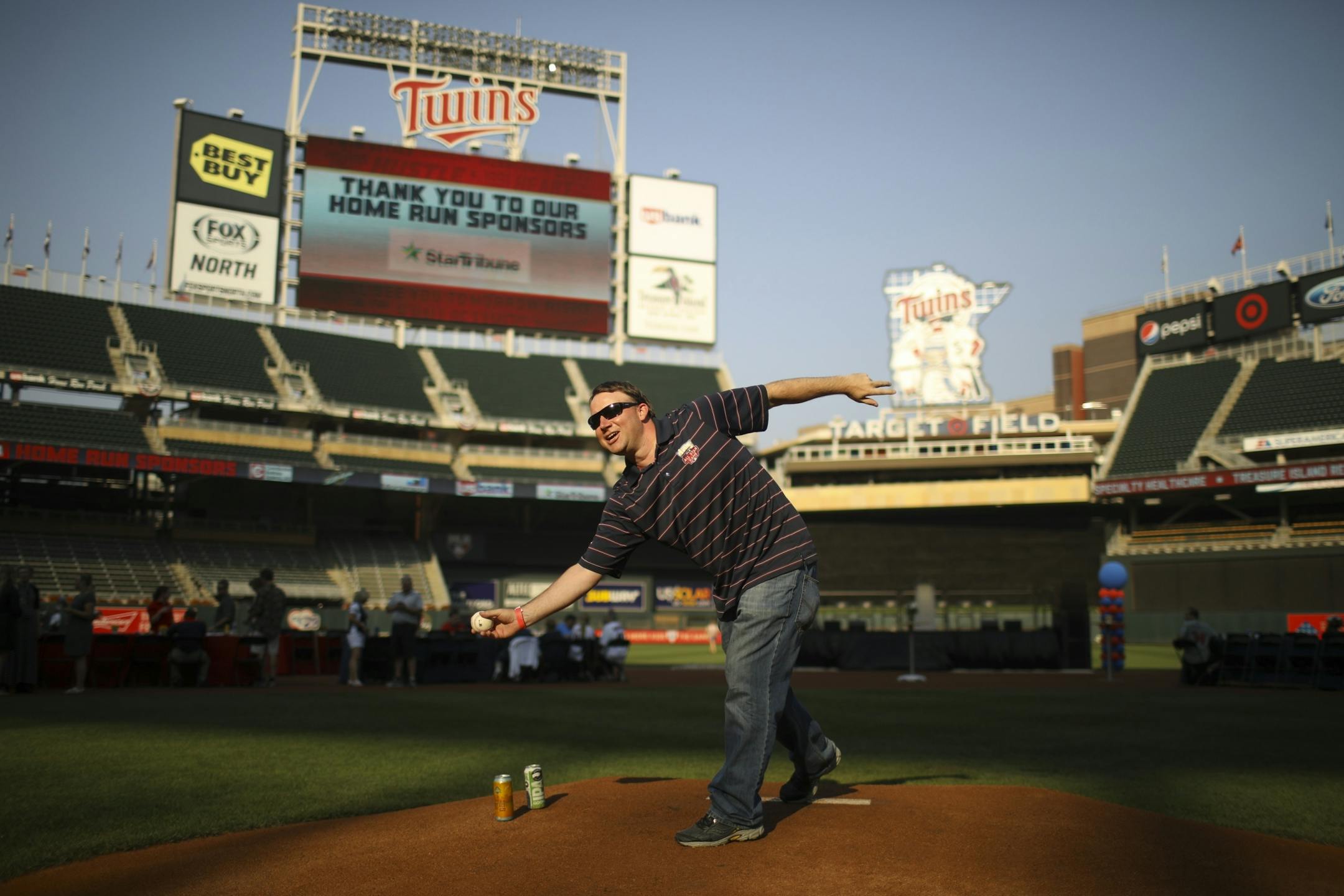 Bryan Nelson set his beer down on the pitcher's mound to pose for a keepsake photo by a buddy.