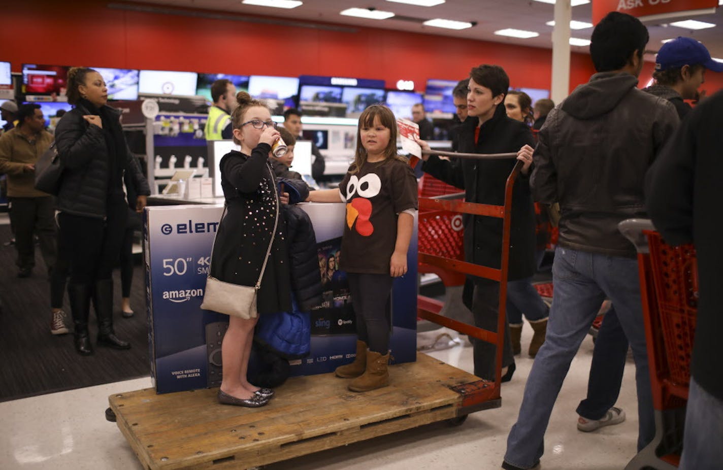 Cousins Dianna, left, and Eleanor Lenz rode on the cart holding a 50" flat screen television pushed by Dianna's mom, Sarah Lenz. ] JEFF WHEELER &#xef; jeff.wheeler@startribune.com The Target Ridgedale location opened it's doors at 6 p.m. for early Black Friday shopping Thanksgiving evening, November 23, 2017 in Minnetonka.