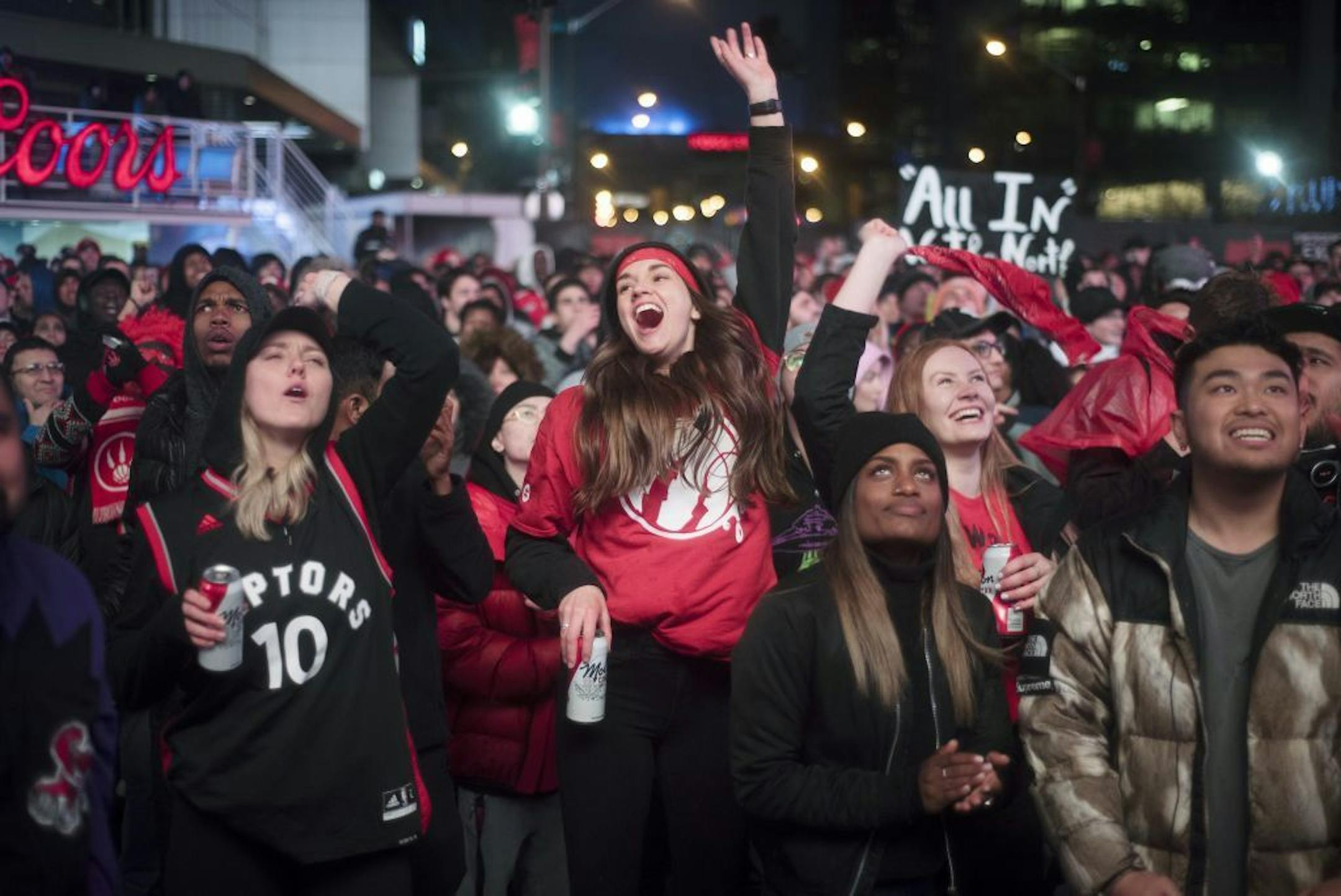 Basketball fans cheer for the Toronto Raptors before claiming victory over the Philadelphia 76ers outside Maple Leaf Square during the second half of an NBA Eastern Conference semifinal basketball game in Toronto on Sunday, May 12, 2019.