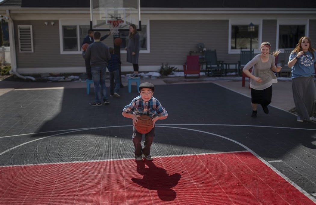 Chance Simons 12, shot baskets during recess, as his sister Dannie Simons (right with grey shirt) and Arianna Howson played at the Ronald McDonald House School.