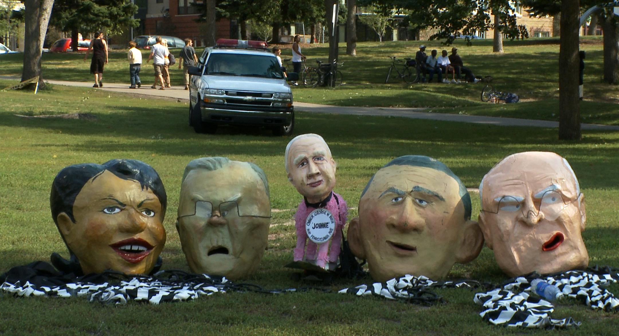 Puppets of Condoleezza Rice, left, Donald Rumsfeld, John McCain as the dog, President George W. Bush and Dick Cheney lie on the ground after the parade. The Backbone Campaign, a grassroots group from Washington State, brought them to Minneapolis for the parade.