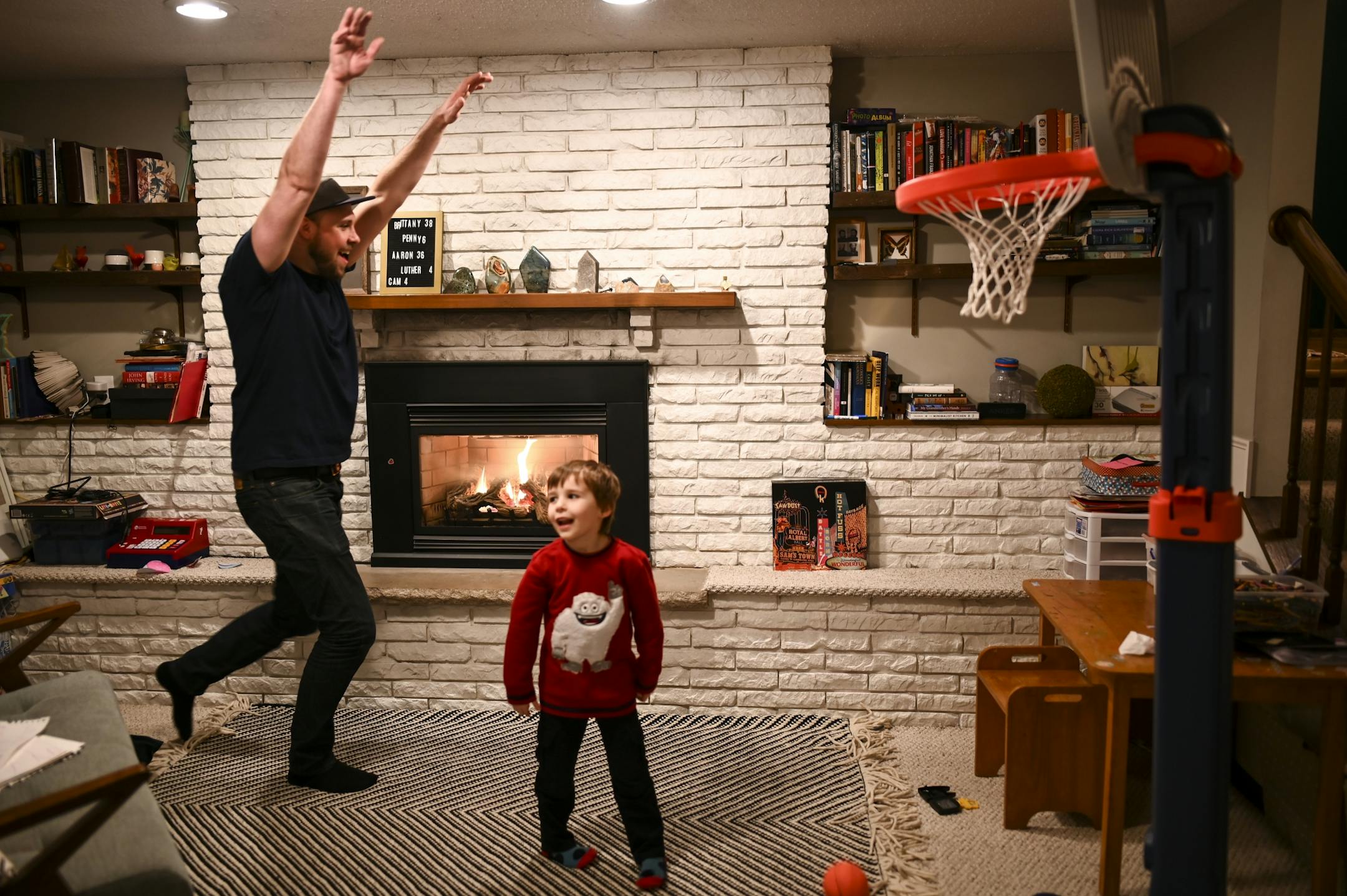 Aaron Mader played hoops with his son Cam, 4, in their home.