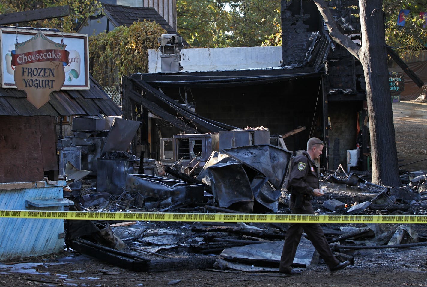 Investigators looked through the rubble after a fire destroyed the Rogues Chicken, Scotch egg, and pizza booths at the Minnesota Renaissance Festival on 9/30/11. There were no injuries reported. Five booths in total were destroyed in the fire.