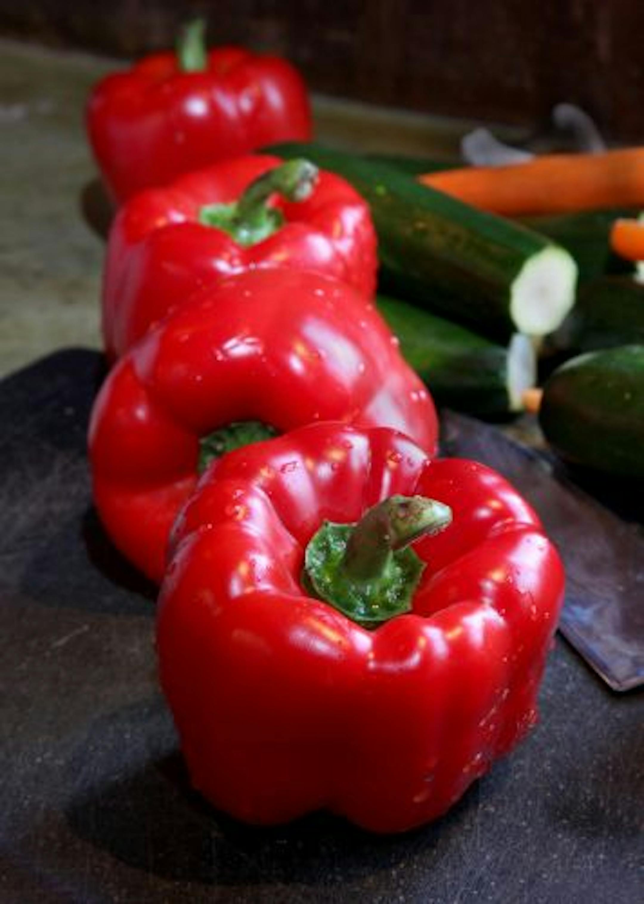 Red bell peppers ready to be cut.