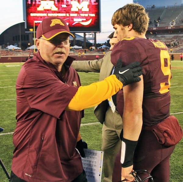 Gophers football coach Jerry Kill congratulated quarterback Philip Nelson at the end of Minnesota's 44-28 victory over Purdue on Saturday.