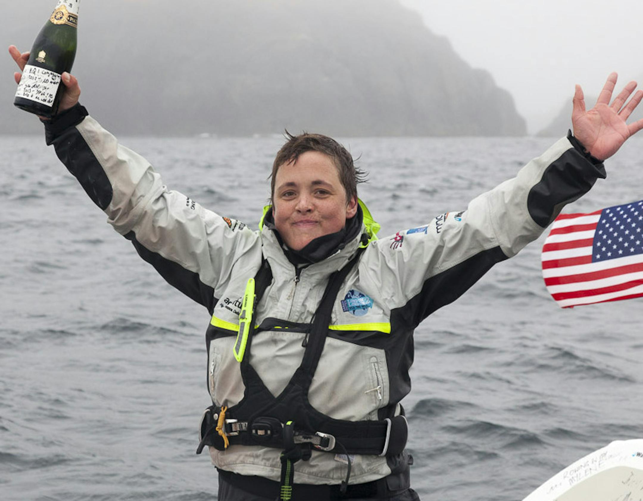 In this image provided by James Sebright, Sarah Outen celebrates after arriving into Adek, Alaska on Monday, Sept. 23, 2013. Outen, a 28-year-old British adventurer, became the first woman to row solo from Japan to Alaska, arriving late Monday at a small town in the Aleutian Islands after 150 days and 3,750 miles at sea. Sarah Outen left Choshi, Japan, on April 27. It is part of her plan for a global trek by an ocean rowing shell, kayak and bike. (AP Photo/James Sebright)