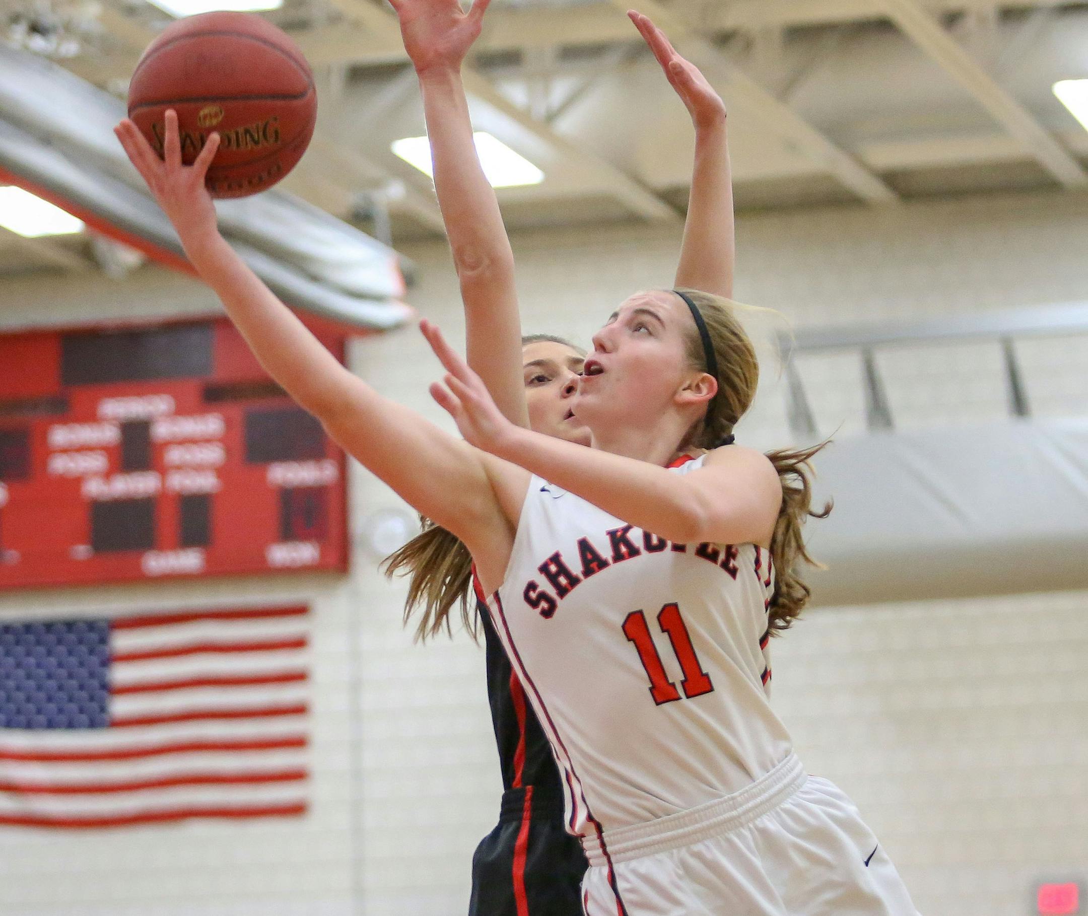 Jaley Coplin (11) drives the lane for two points early in the first half. Coplin's three-pointer with 2:11 left in the game gave the Sabers a 40-37 lead. Shakopee, the third seed, upset first seed Eden Prairie 41-39 to capture the Class 4A, Section 2 title at Eden Prairie High School. Photo by Cheryl Myers, SportsEngine