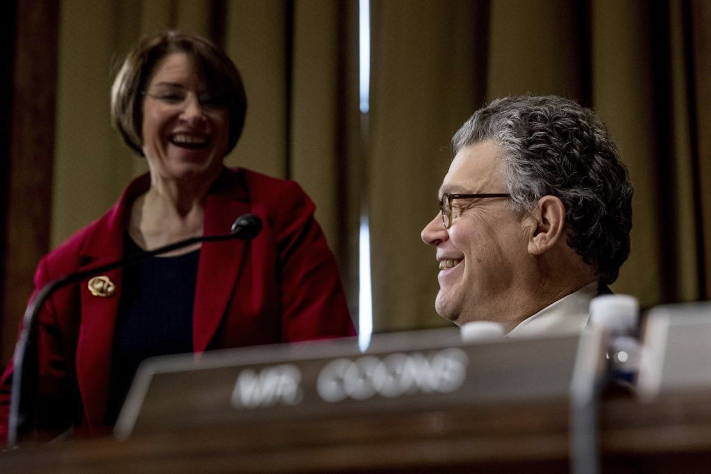 Senate Judiciary Committee members, Sen. Al Franken, D-Minn., right, and Sen. Amy Klobuchar, D-Minn. speak on Capitol Hill in Washington, Tuesday, Jan. 31, 2017, at the start of the committee's business meeting to discuss the nomination of Attorney General-designate, Sen. Jeff Sessions, R-Ala.