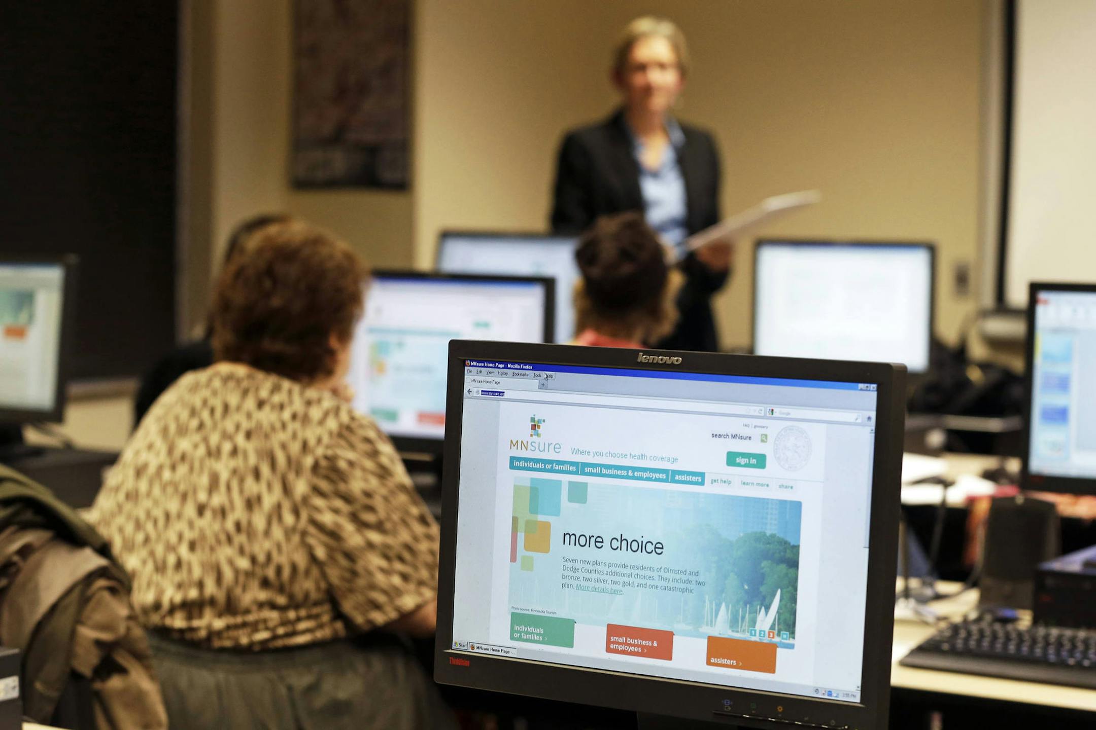 ADVANCE FOR MONDAY, NOV. 25 - In this photo made Wednesday, Nov. 13, 2013, Maureen O'Connell addresses people in attendance at the "MNsure Crash Course" at the St. Paul Library to help them understand how federal health care reform affects their lives. O'Connell is the co-founder and project manager for Health Access MN, a major beneficiary of $3.91 million from a federal government grant to private groups that pledge to recruit Minnesotans to sign up for coverage through the state's MNsure heal