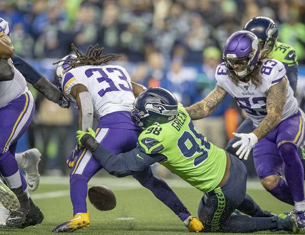 Vikings running back Dalvin Cook fumbled the ball before being injured by Seahawks defensive end Rasheem Green during the third quarter. ] ELIZABETH F