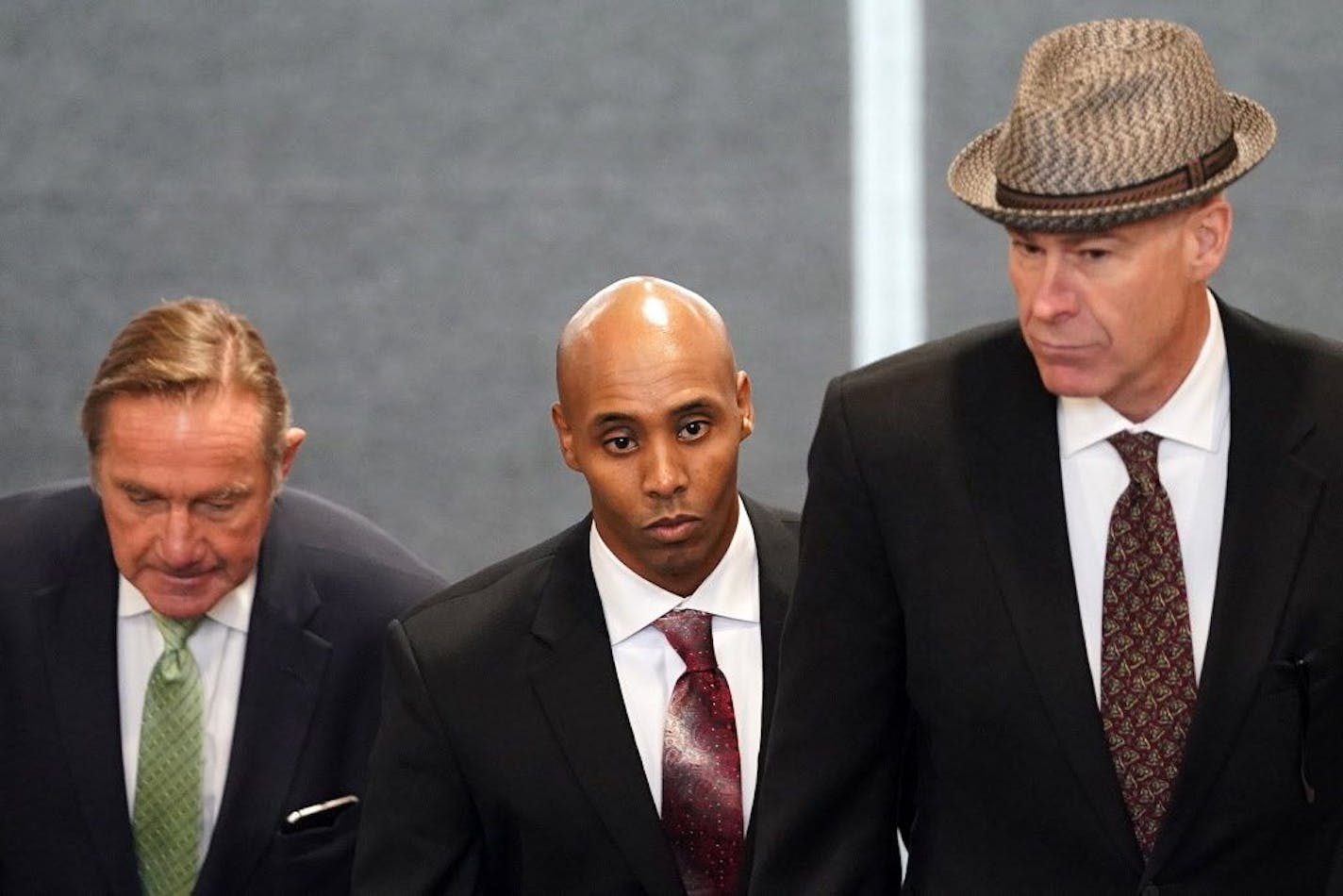 Mohamed Noor, center, accompanied by his legal team, Peter Wold, left, and Tom Plunkett, right, arrived to argue pretrial motions at a probable cause hearing for the ex-Minneapolis cop Thursday at the Hennepin County Government Center.