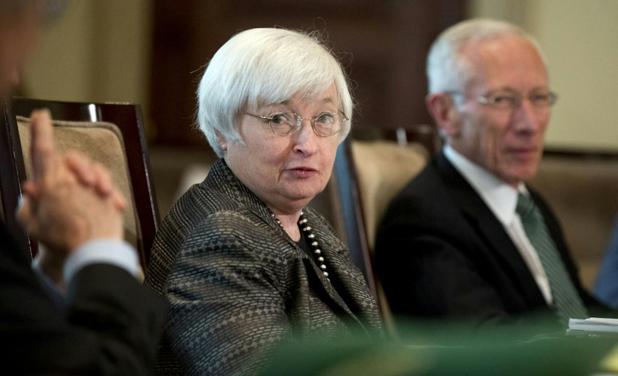 FILE - In this July 20, 2015, file photo, Federal Reserve Chair Janet Yellen, from left, with Vice Chairman Stanley Fischer, and the board of governors of the Federal Reserve System, presides over a meeting in Washington. Nine years after they last raised their benchmark interest rate and after months of feverish speculation, Federal Reserve policymakers this week may finally raise that rate from a record low near zero. (AP Photo/Manuel Balce Ceneta, File)