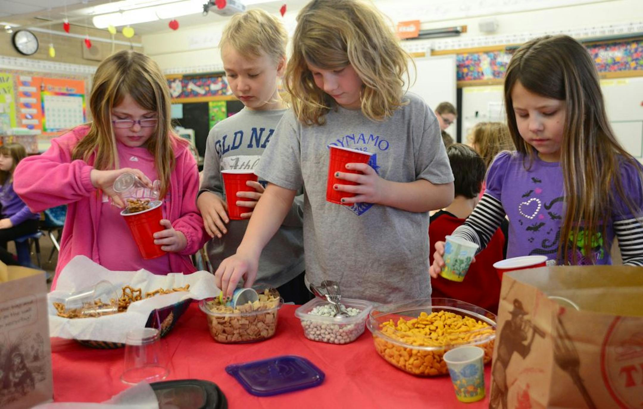 Third graders at Glen Lake Elementary School in Minnetonka, Minn. are having their monthly celebration, where they are get to choose their own snacks at a buffet styled snack fest of chips, cereal and and dried fruits. Third graders Sarah Chollar,Liam McAllister, Hannah Rindels and Rain Lee-Kolhoff dug into their afternoon snacks