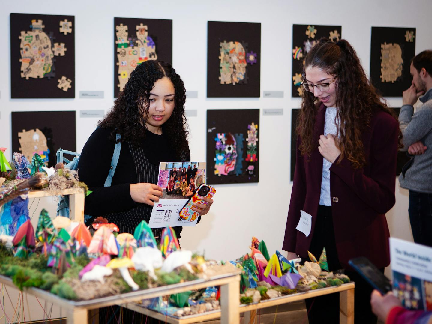 &nbsp;Visitors at the community celebration for The World Inside You, exploring the exhibit on May 6, 2023. Photos by Ryan Stopera for the Weisman Art Museum.