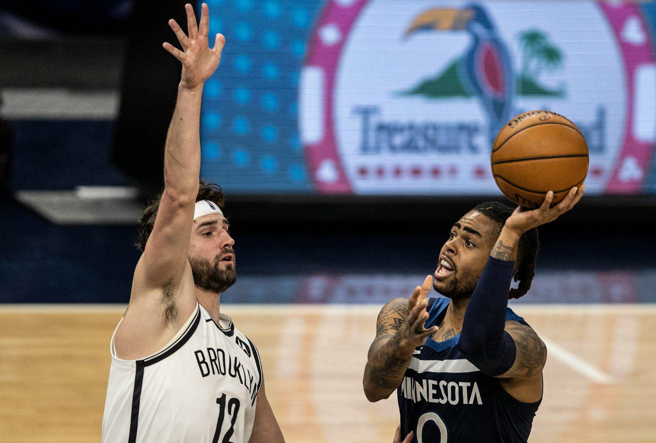 Minnesota Timberwolves guard D'Angelo Russell (0) missed an off balanced shot over Brooklyn Nets forward Joe Harris (12) at Target Center April 13, 2021 in Minneapolis.