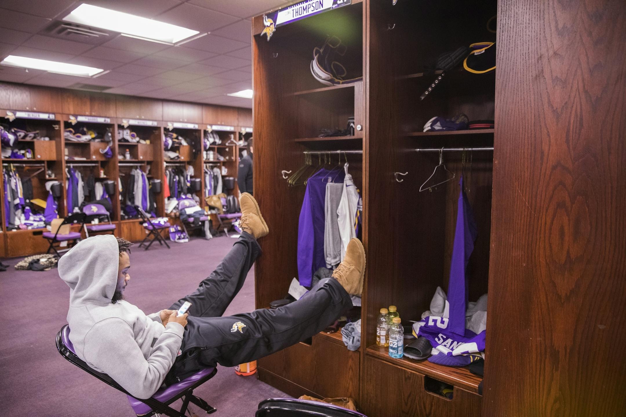 Cedric Thompson relaxes in the locker room.