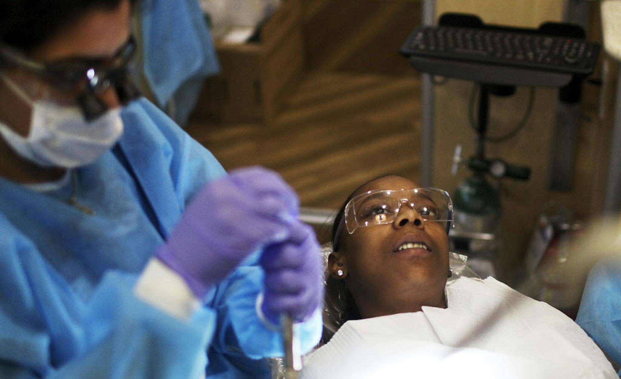 Hopes for a better life drew Duke Johnson to Minneapolis. At People Serving People, his wife, Angela, above, got dental care.