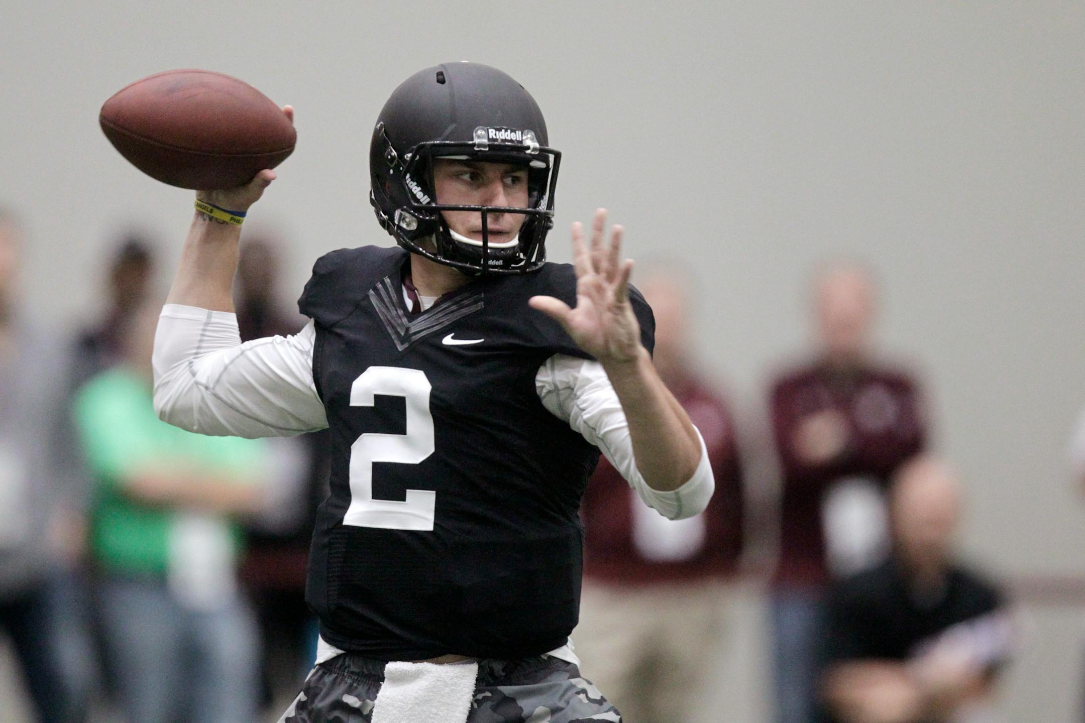 Texas A&M quarterback Johnny Manziel passes the ball during a drill at pro day for NFL football representatives in College Station, Texas, Thursday, March 27, 2014. (AP Photo/Patric Schneider)