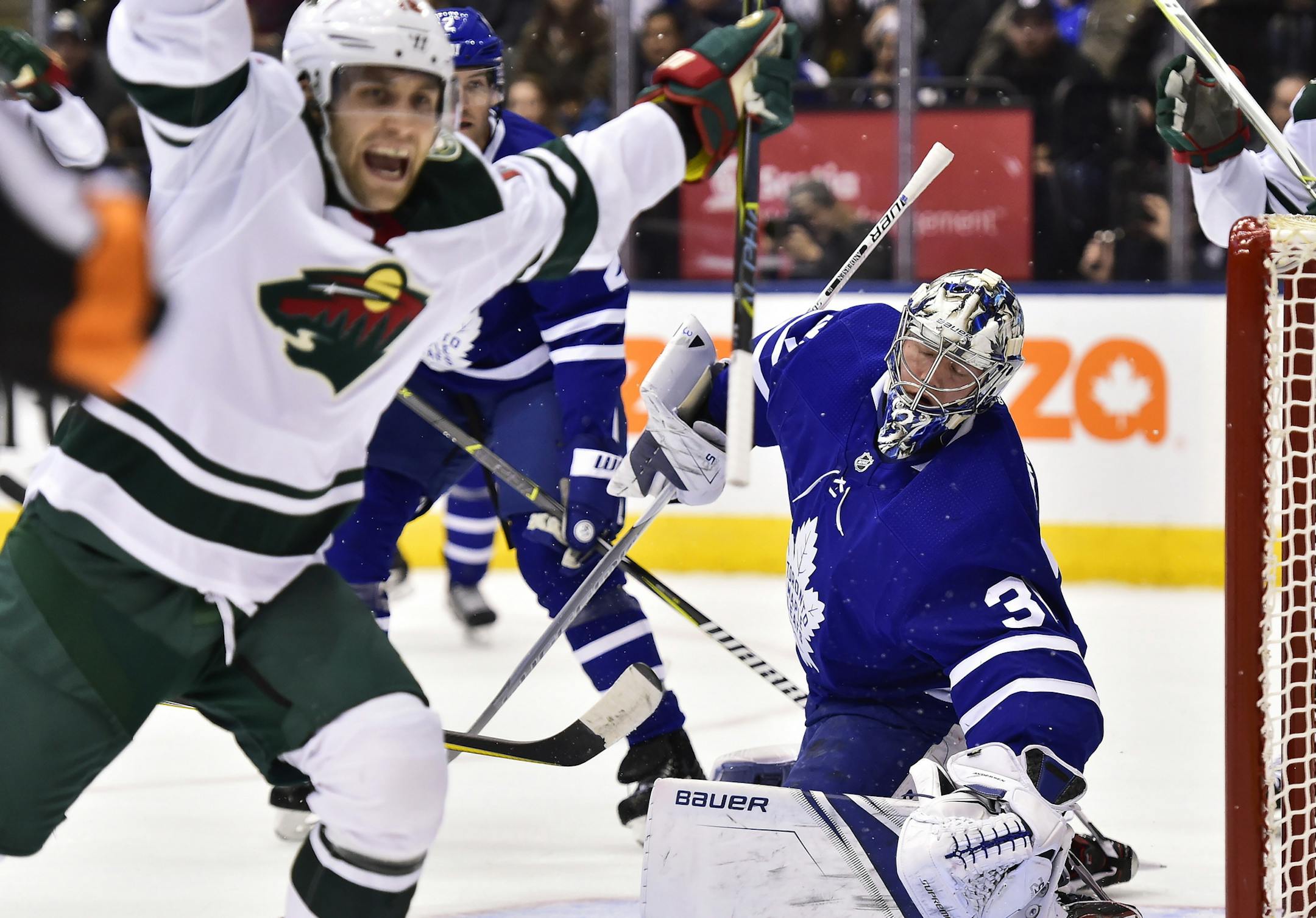 Minnesota Wild left wing Jason Zucker (16) celebrates after scoring on Toronto Maple Leafs goalie Frederik Andersen (31) during the first period of an NHL hockey game Wednesday, Nov. 8, 2017, in Toronto. (Frank Gunn/The Canadian Press via AP)