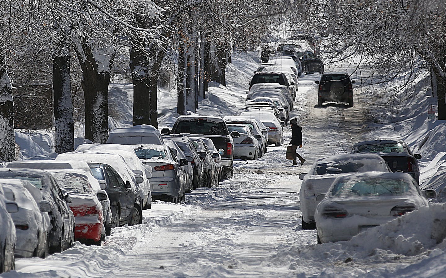 Vehicles lined the S. Garfield Ave. near W. Franklin Ave., where heavy snow this season has narrowed the roadway.