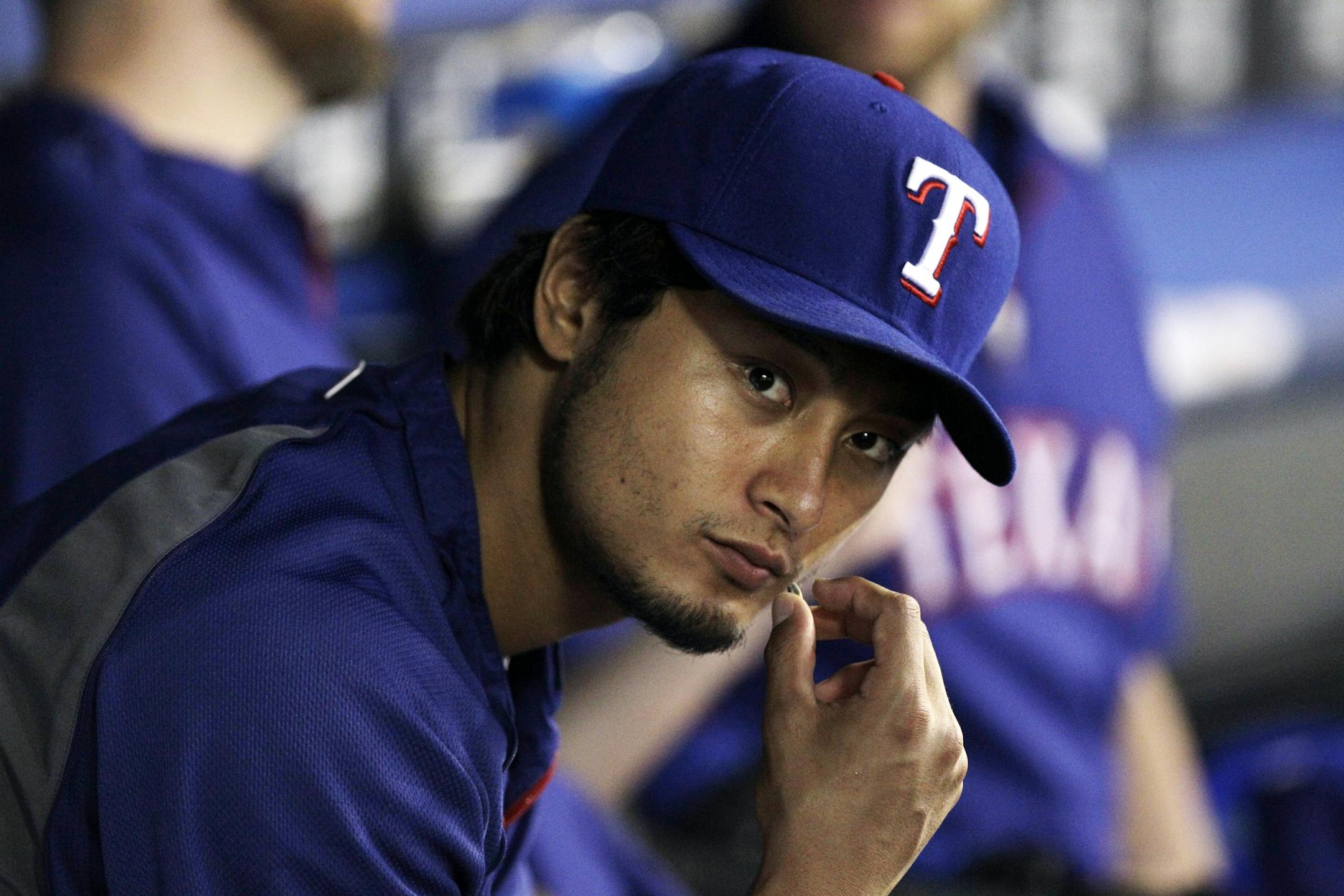 Texas Rangers starting pitcher Yu Darvish, of Japan, sits in the dugout during a baseball game against the Minnesota Twins, Thursday Aug. 23, 2012, in Arlington, Texas.
