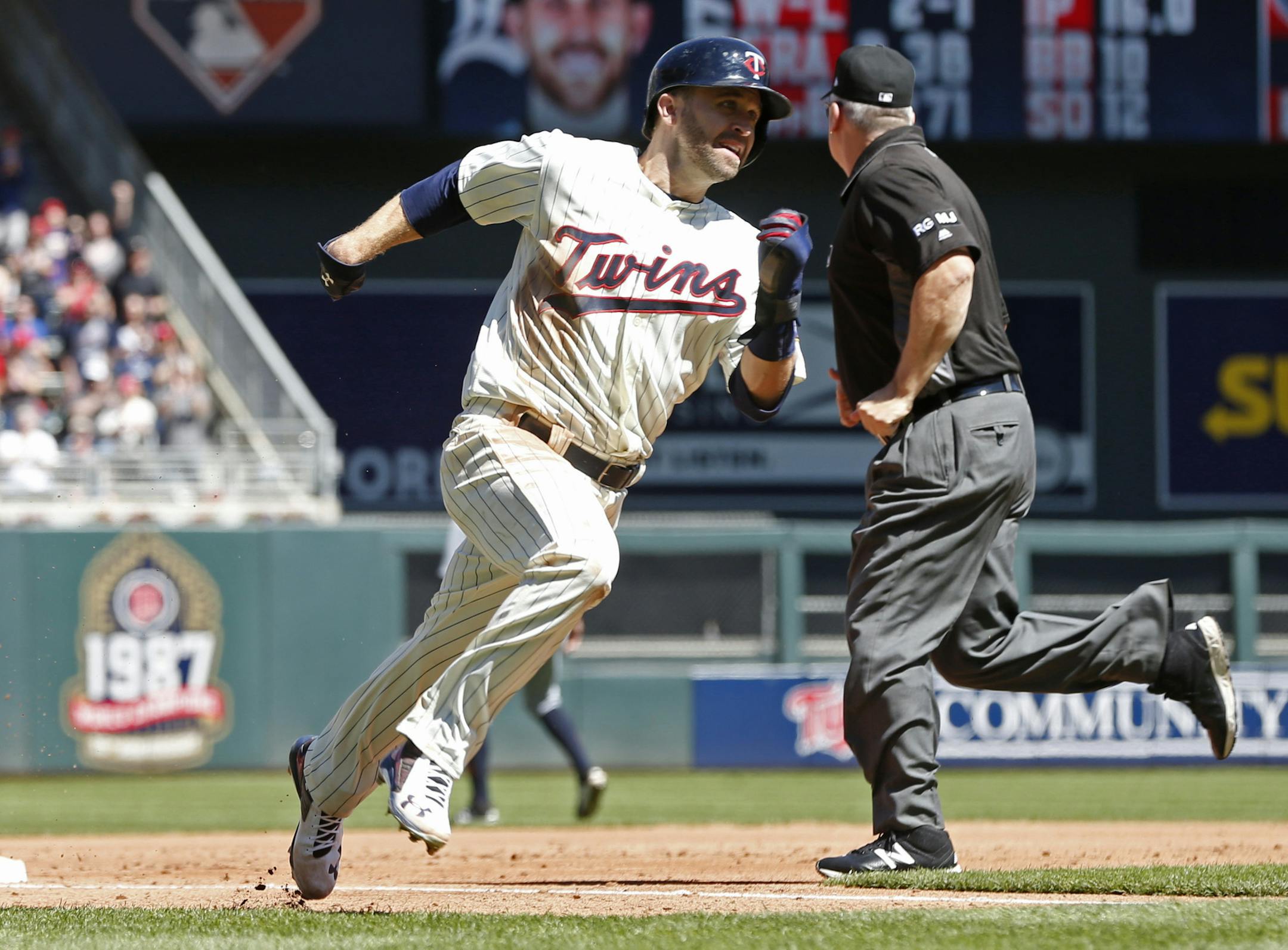 Minnesota Twins' Brian Dozier races home on a two-run double by Jorge Polanco off Detroit Tigers pitcher Matthew Boyd in the second inning of a baseball game Saturday, April 22, 2017, in Minneapolis. (AP Photo/Jim Mone)