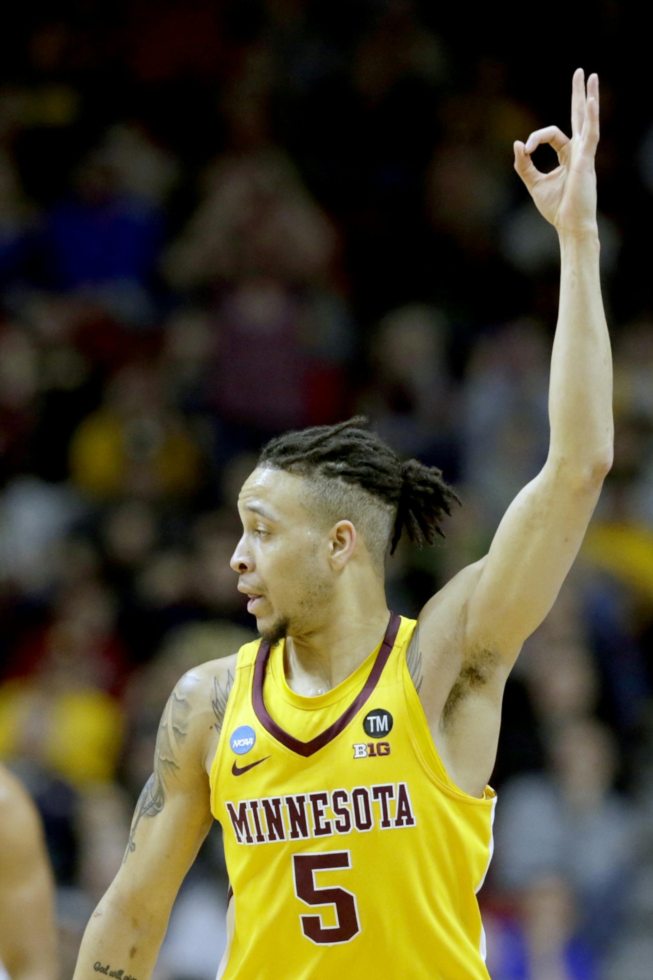 Minnesota's Amir Coffey (5) celebrates a three point basket during the first half of a first round men's college basketball game against Louisville in the NCAA Tournament, in Des Moines, Iowa, Thursday, March 21, 2019.