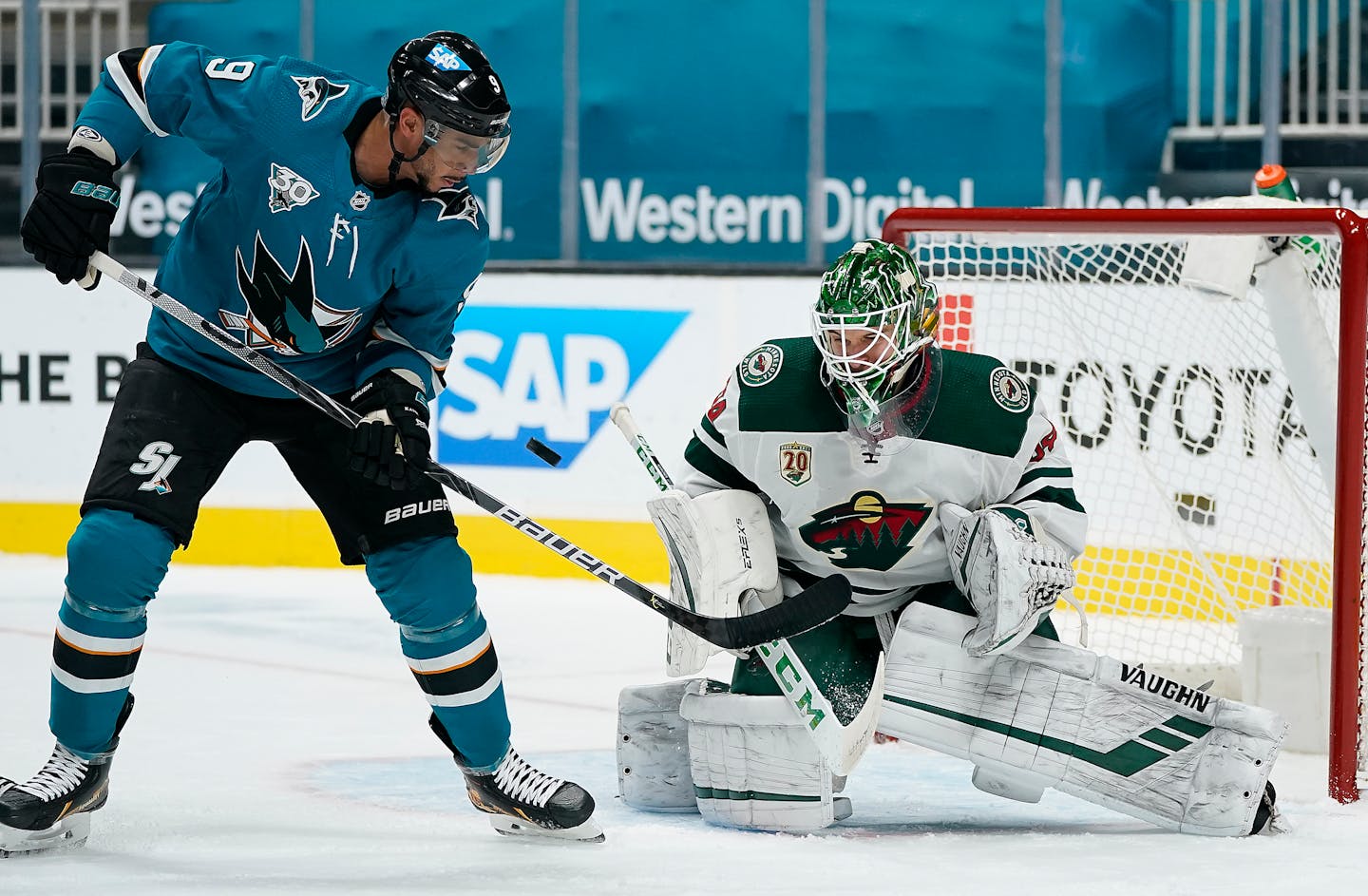 Minnesota Wild goaltender Kaapo Kahkonen (34) blocks a shot by San Jose Sharks left wing Evander Kane (9) during the first period of an NHL hockey game in San Jose, Calif., Monday, Feb. 22, 2021. (AP Photo/Tony Avelar)