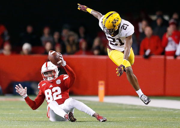 Nebraska's wide receiver Alonzo Moore made a grab despite Gophers defensive back Ray Buford's efforts during the fourth quarter on Nov. 12.