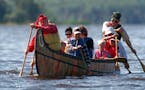 In this Star Tribune file photo, visitors to Voyageurs National Park ride in a 26-foot replica of a voyageurs canoe on Rainy Lake. Costumed interprete