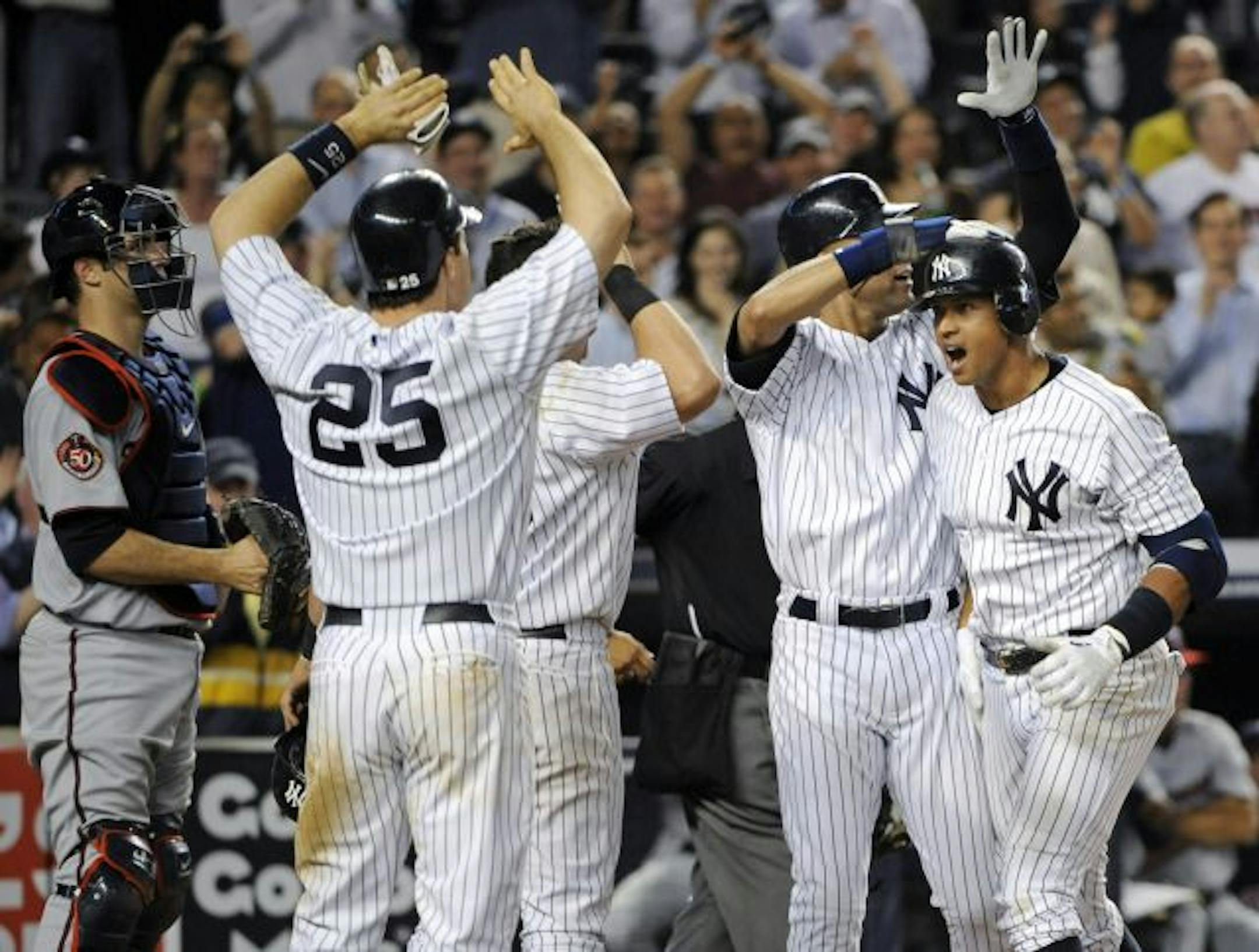 Alex Rodriguez, right,was greeted by Yankees teammates Derek Jeter, Francisco Cervelli and Mark Teixeira (25) after hitting a grand slam during the seventh inning on Friday