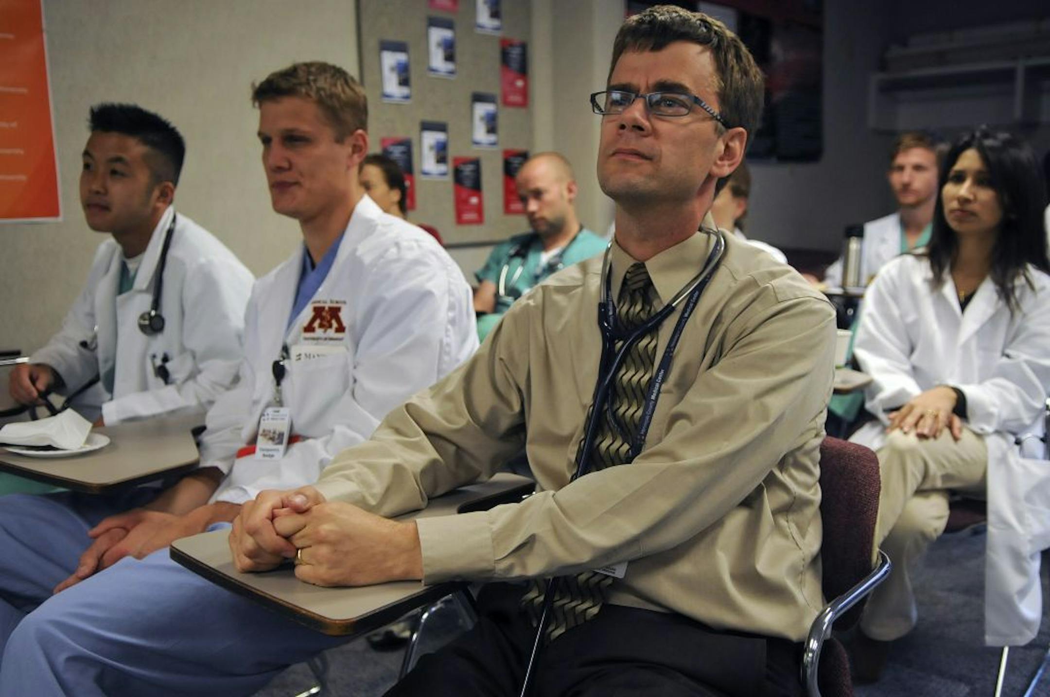 Dr. David Hilden watched patient reviews Tuesday at Hennepin County Medical Center in Minneapolis. Hilden was a family physician for six years, but burned out. "You never feel caught up," he said. "The pressures of the clock are extreme." Now he cares for hospital patients.