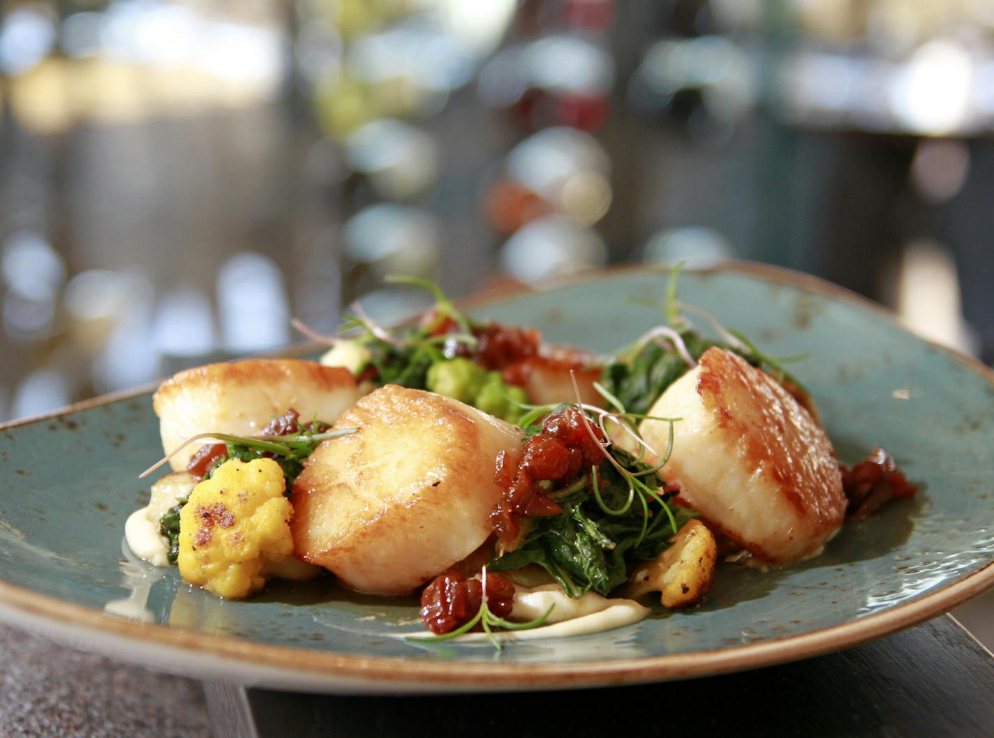 Seared scallops with roasted cauliflower and a cauliflower pur&#xe9;e.