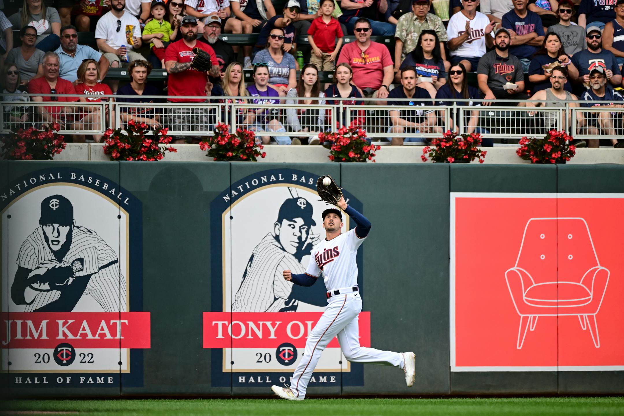 Minnesota Twins left fielder Trevor Larnach (13) catches a deep fly ball hit by New York Yankees second baseman Gleyber Torres (25) in the top of the first inning.