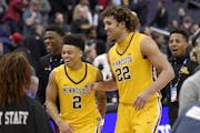 Minnesota center Reggie Lynch (22) and guard Nate Mason (2) react as they leave the court after an NCAA college basketball game against Michigan State