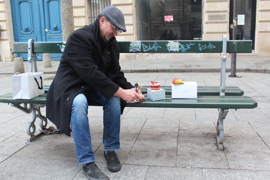 Twin Cities pastry chef John Kraus sits on a bench in the St. Germain-de-Prés neighborhood of Paris and samples his first round of sweets.