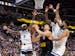 Nikola Jokic (25) of the Denver Nuggets is defended by Nickeil Alexander-Walker (9), Naz Reid (11), and Karl Anthony Towns (32) of the Timberwolves in